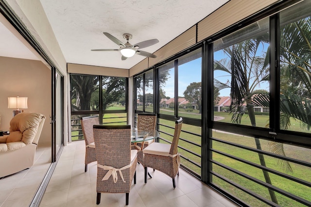 sunroom featuring ceiling fan