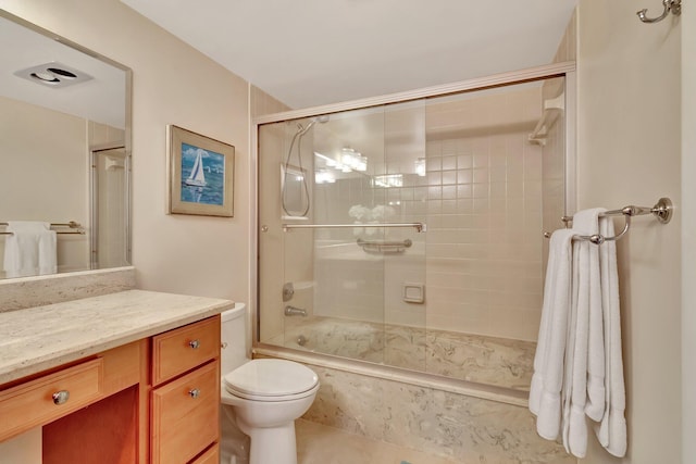 full bathroom with vanity, tile patterned flooring, shower / bath combination with glass door, and toilet