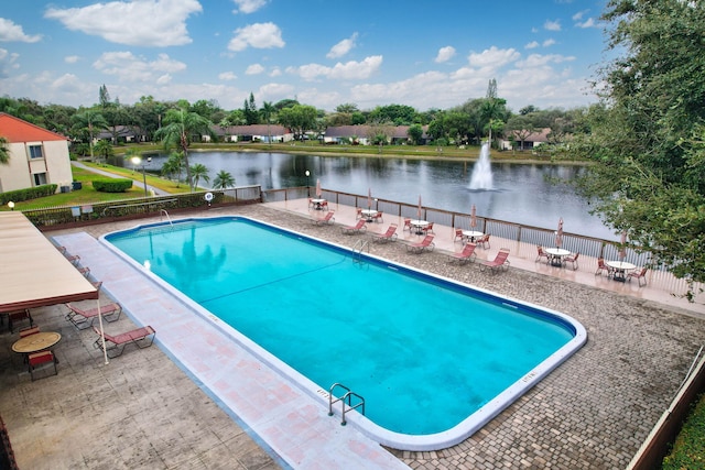 view of swimming pool with a water view and a patio area