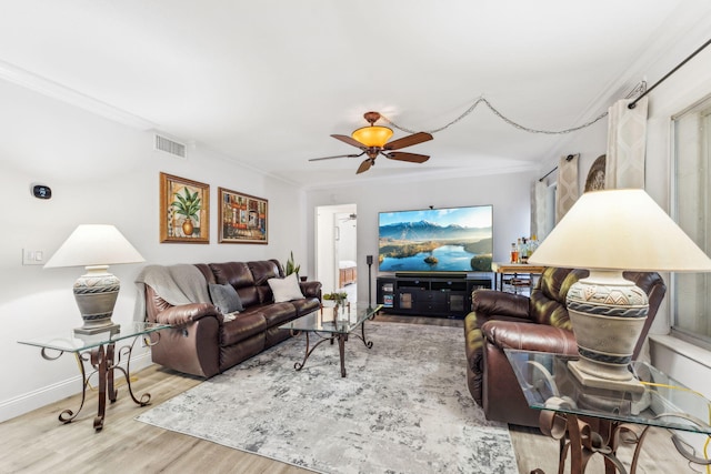 living room featuring ornamental molding, hardwood / wood-style floors, and ceiling fan