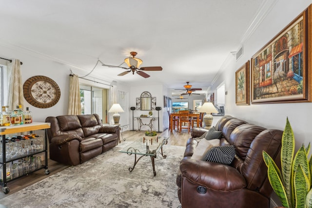 living room featuring crown molding, ceiling fan, and hardwood / wood-style floors