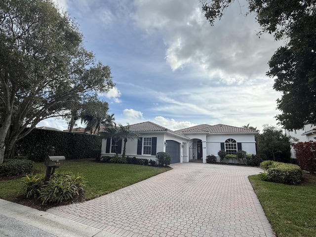 view of front of property with a front lawn and a garage