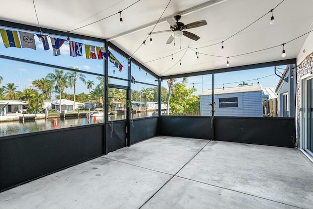 unfurnished sunroom with a water view, ceiling fan, and lofted ceiling