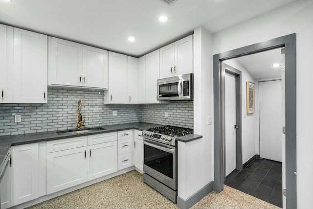 kitchen with white cabinetry, sink, tasteful backsplash, and appliances with stainless steel finishes