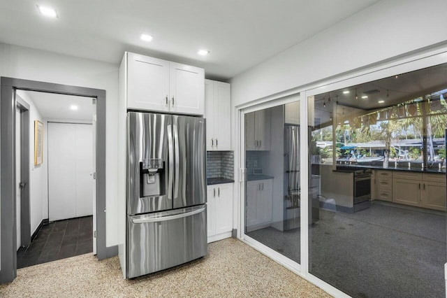 kitchen featuring tasteful backsplash, stainless steel appliances, and white cabinets