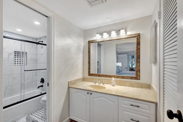 full bathroom with toilet, vanity, tile patterned floors, and shower / bath combination with glass door