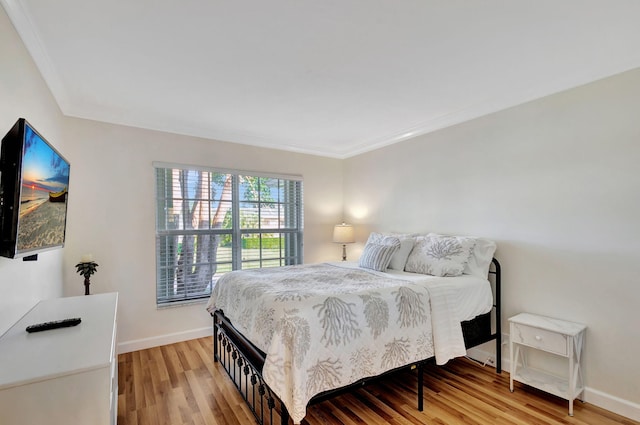 bedroom featuring crown molding and hardwood / wood-style floors