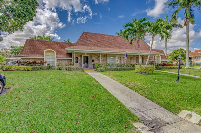 view of front of home with a front yard and a porch