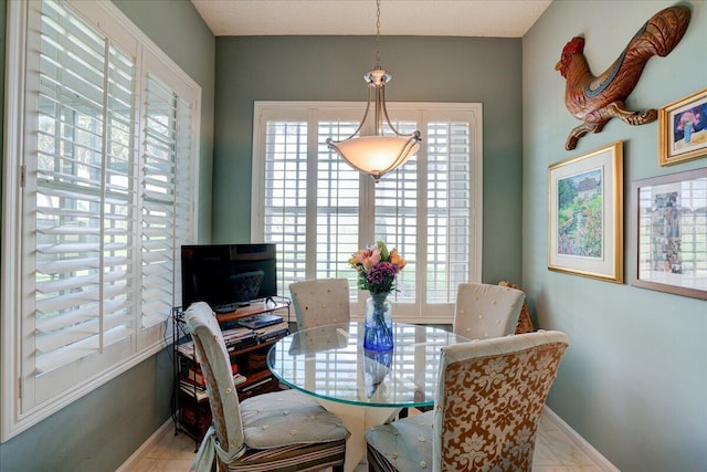 dining area featuring light tile patterned flooring