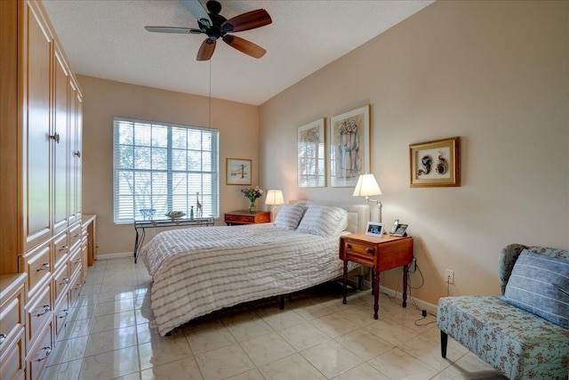 tiled bedroom with ceiling fan and a textured ceiling