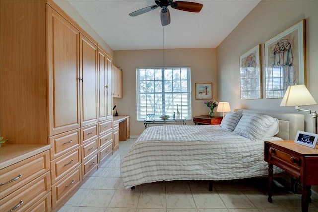 bedroom with ceiling fan and a textured ceiling