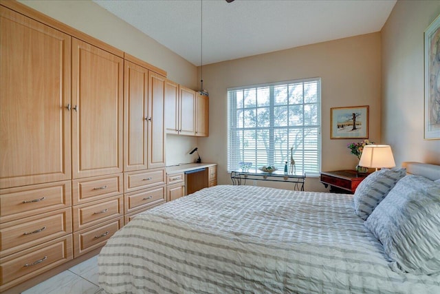 bedroom with light tile patterned floors and a textured ceiling