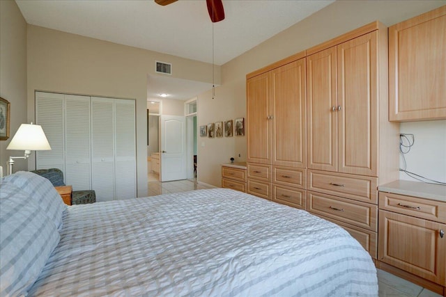 tiled bedroom with ceiling fan