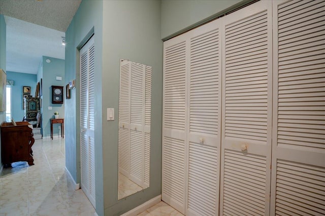 hallway with a textured ceiling