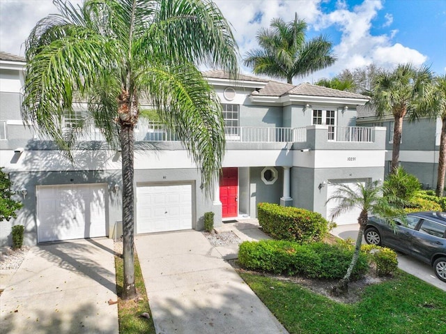 view of property featuring a balcony and a garage