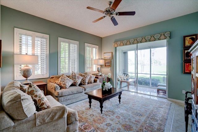 tiled living room with ceiling fan and a textured ceiling