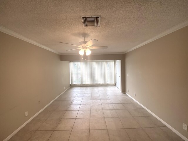 spare room with ceiling fan and light tile patterned floors