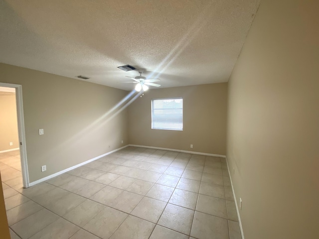 interior space with ceiling fan, a textured ceiling, and light tile patterned floors