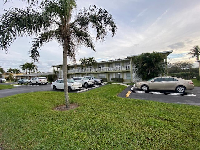 view of vehicle parking with a lawn