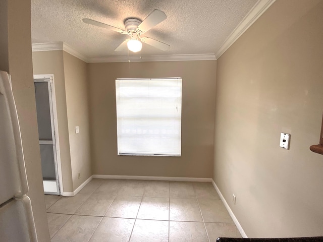 tiled spare room featuring ceiling fan, plenty of natural light, a textured ceiling, and ornamental molding