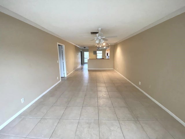 spare room with crown molding, ceiling fan, and light tile patterned flooring