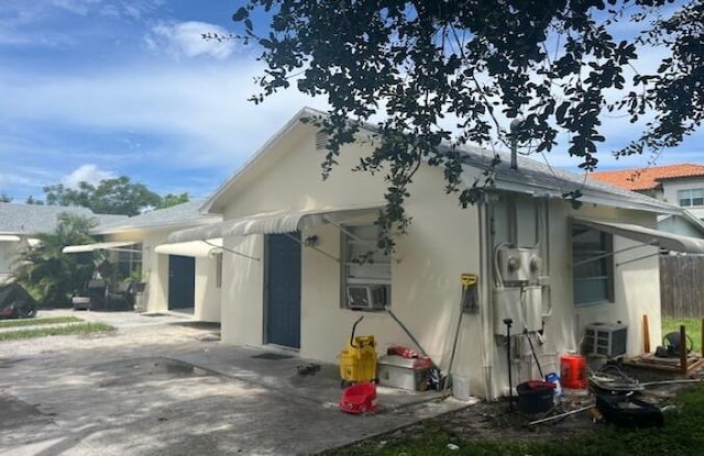 view of side of home with ac unit