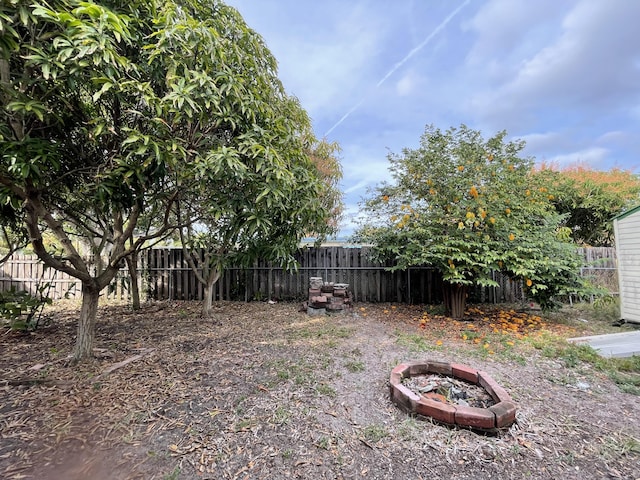 view of yard with a fire pit