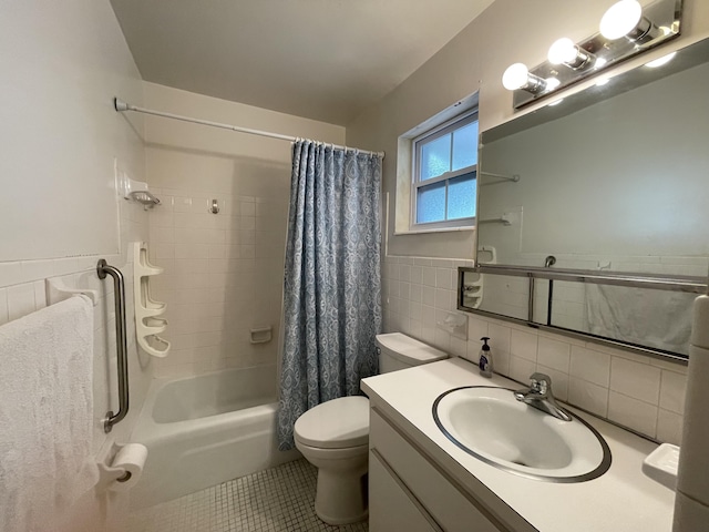 full bathroom with toilet, tile walls, tile patterned floors, vanity, and shower / bathtub combination with curtain