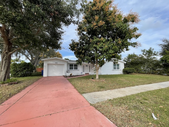 view of front of property featuring a garage and a front lawn