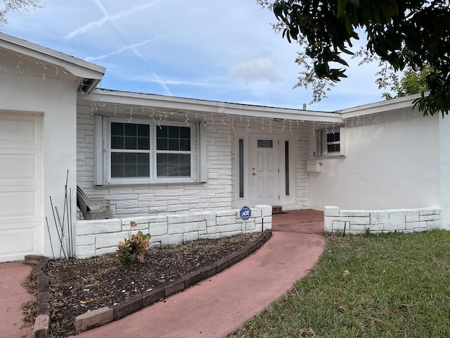 doorway to property with a garage