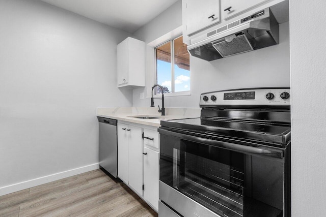 kitchen with white cabinetry, appliances with stainless steel finishes, sink, and light hardwood / wood-style flooring