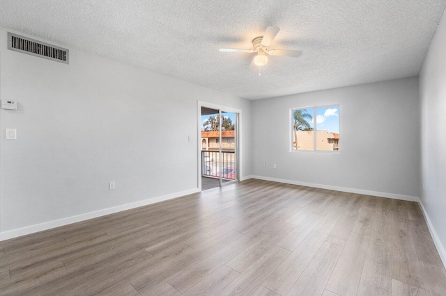 spare room with wood-type flooring, a textured ceiling, and ceiling fan