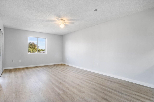 spare room with a textured ceiling, light hardwood / wood-style flooring, and ceiling fan