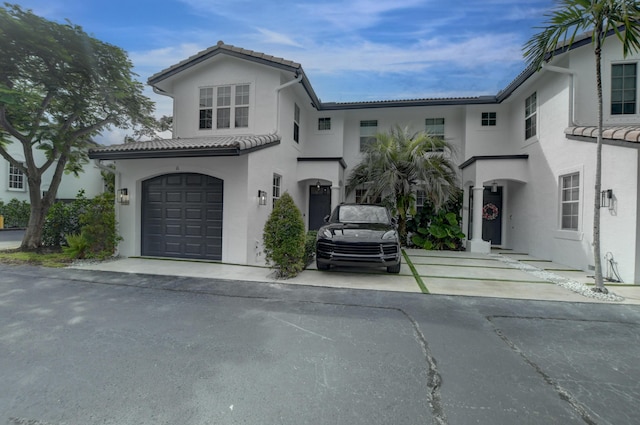 mediterranean / spanish house with a garage