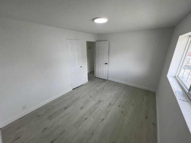 spare room featuring light hardwood / wood-style flooring