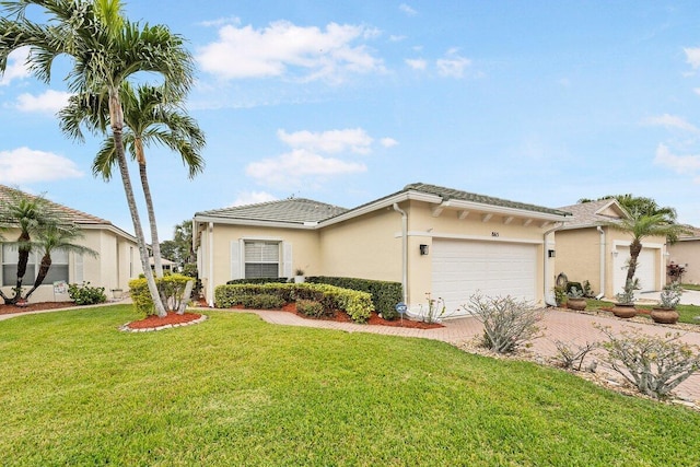 view of front of home with a garage and a front lawn