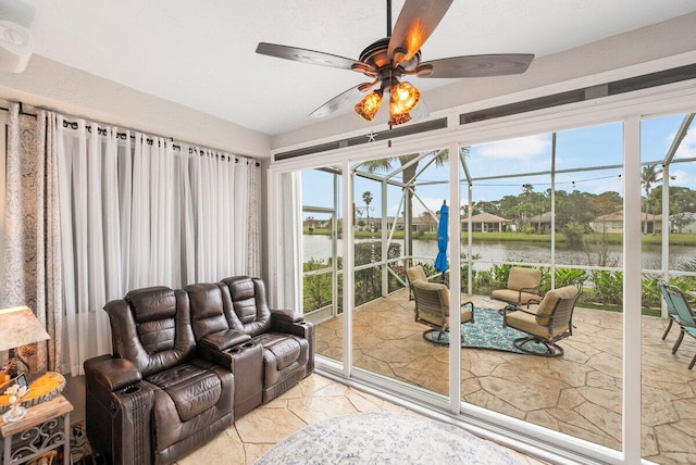 interior space with light tile patterned flooring, a water view, and ceiling fan