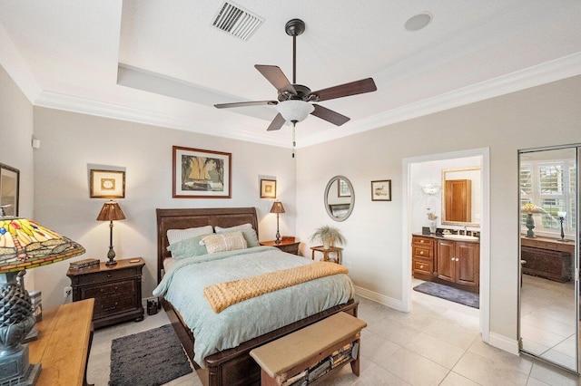 bedroom with ceiling fan, ornamental molding, connected bathroom, and light tile patterned floors