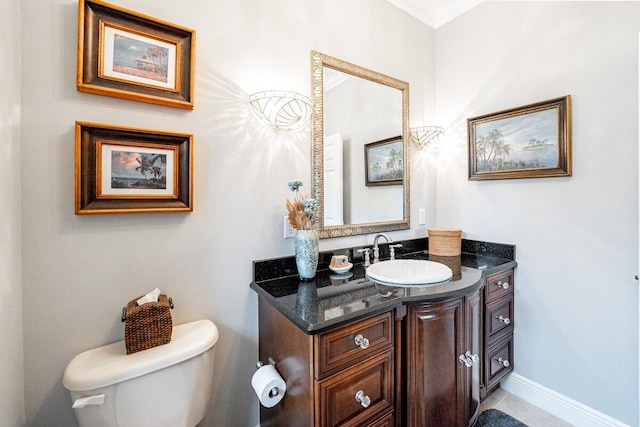 bathroom with ornamental molding, vanity, and toilet