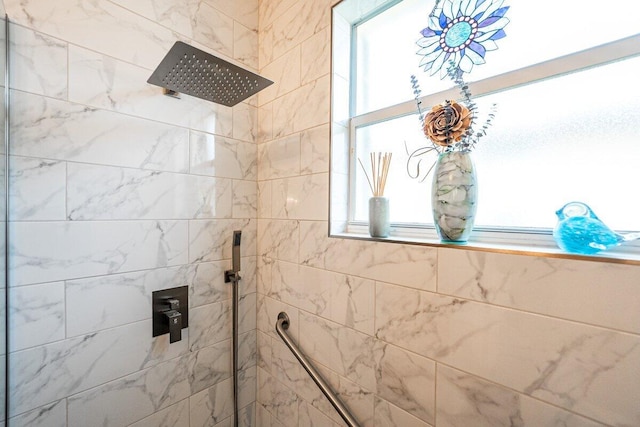 bathroom with plenty of natural light and a tile shower