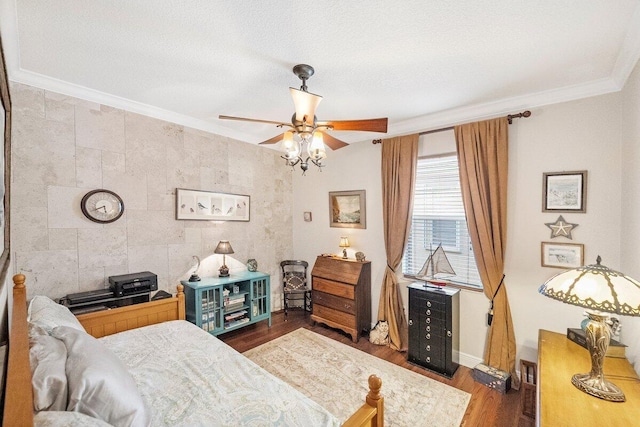 bedroom with tile walls, ornamental molding, ceiling fan, dark wood-type flooring, and a textured ceiling