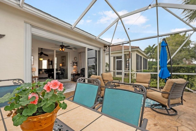 view of patio featuring a lanai and ceiling fan