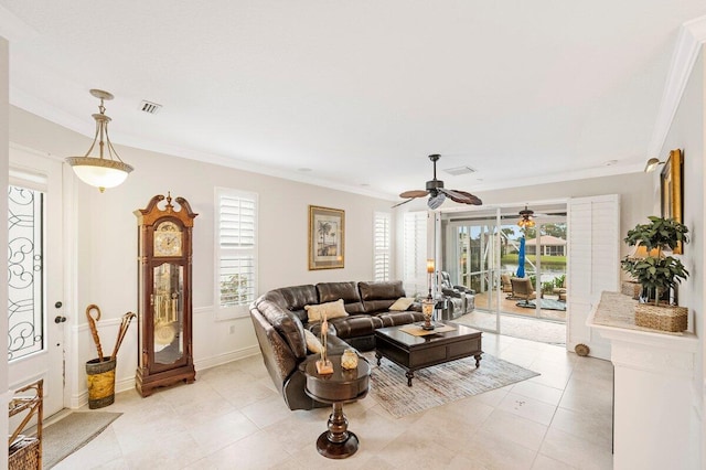 tiled living room with crown molding, ceiling fan, and plenty of natural light