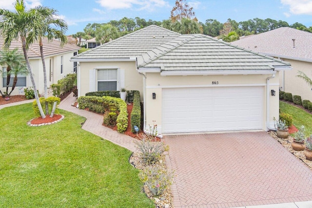 single story home with a garage and a front lawn