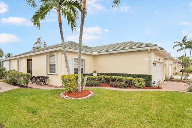 view of front of home with a garage and a front yard