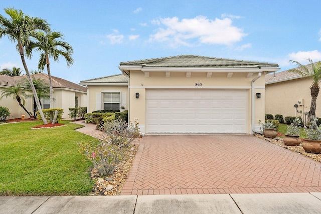 view of front of house with a garage and a front yard