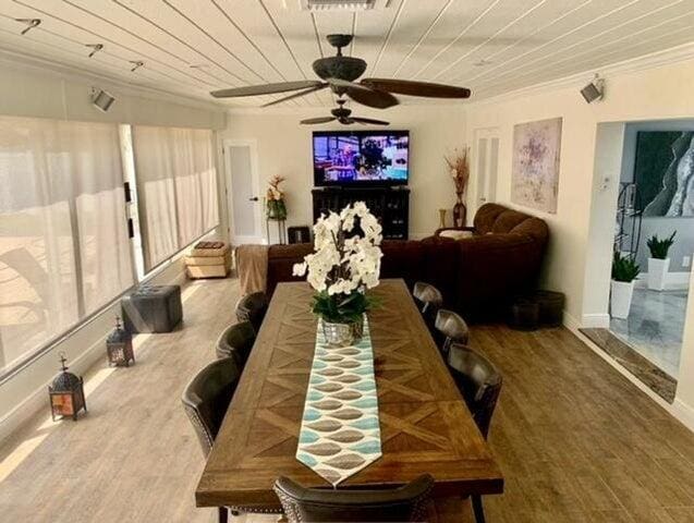 dining space featuring ceiling fan, hardwood / wood-style flooring, crown molding, and wooden ceiling