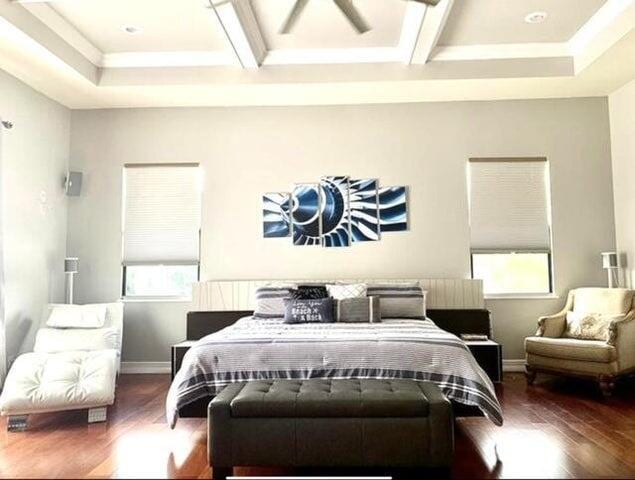 bedroom featuring dark wood-type flooring and coffered ceiling