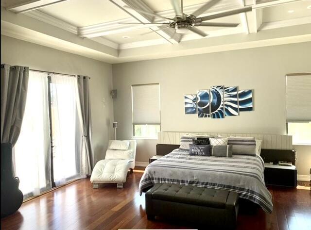 bedroom with ceiling fan, access to outside, beamed ceiling, and coffered ceiling