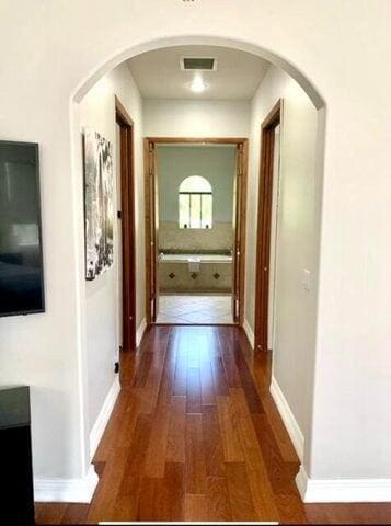 hall with dark wood-type flooring